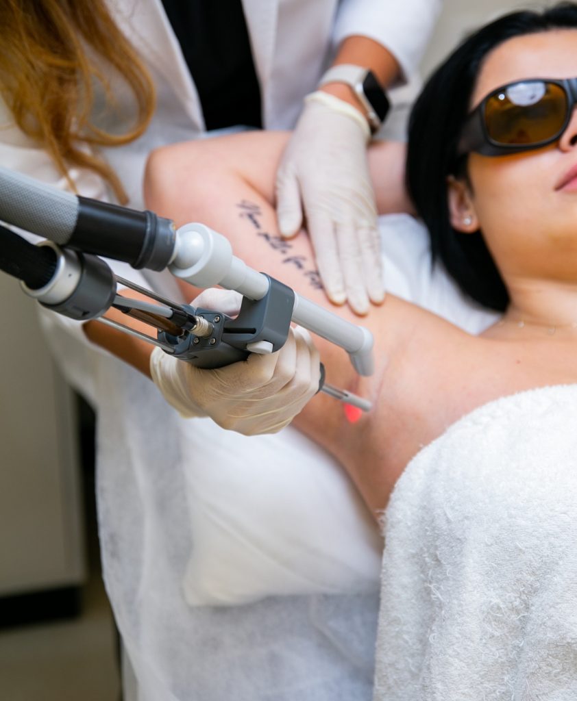 a girl getting her hair removed by laser removel